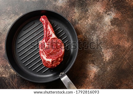 Spencer steak on the grill pan skillet or Scotch Fillet raw top view. ove rustic metal dark background table. with space for text