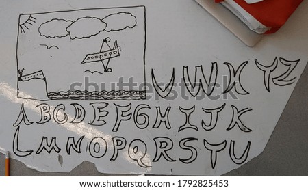 Alphabet doodle with airplane drawing and a homework folder