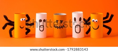 Collection of Monsters from toilet tube on orange for halloween decor. A terrible craft. School and kindergarten. Handcraft creative idea, seasonal autumn holiday pattern, banner, flyer