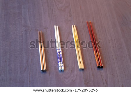 different types of chopsticks on blue wooden background