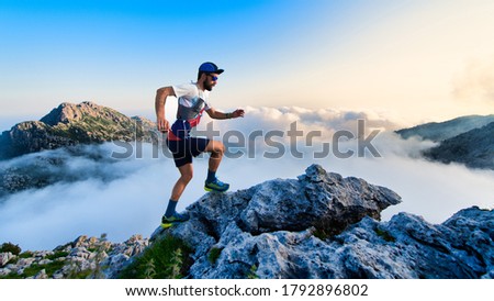 Man ultramarathon runner in the mountains during a workout Royalty-Free Stock Photo #1792896802