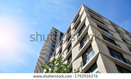 New housing landscape. Facade of a new multi-story residential building. Royalty-Free Stock Photo #1792926376
