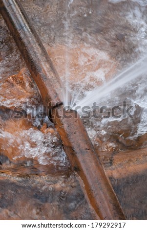 burst water pipe  cast iron in stream Royalty-Free Stock Photo #179292917