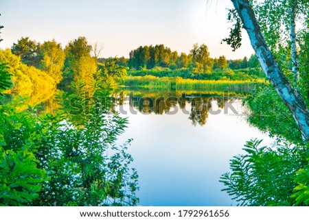 Lake water sunset and nature spring landscape with blue lake water