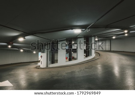 Circular climb to the parking. Underground garage parking. Automobile parking inside.