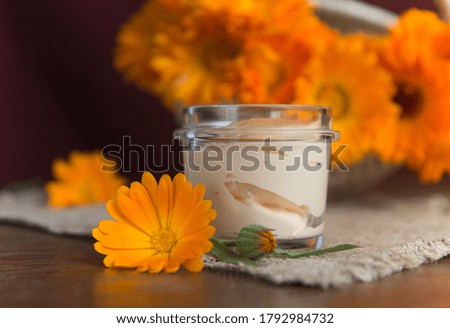 Herbal cosmetics with calendula flowers.Homemade natural cream.