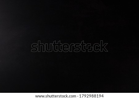 Black Paper Background with light from left side. COPY SPACE.
