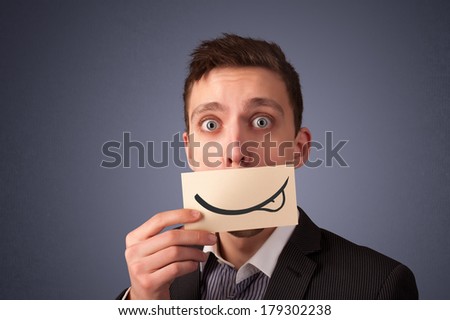 Happy businessman holding funny white card on his mouth with gradient background