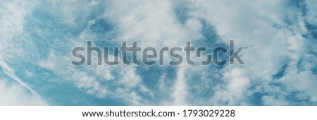 Blue sky with clouds, retro toning, natural abstract background and texture. Banner format