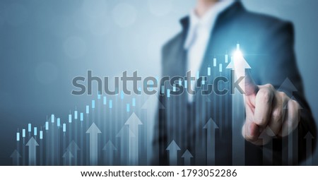 Business development to success and growing annual revenue growth concept, Businessman pointing arrow graph corporate future growth plan Royalty-Free Stock Photo #1793052286
