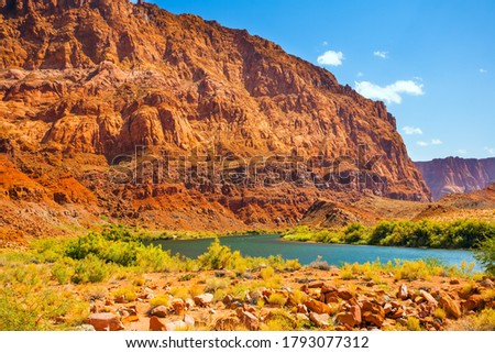 USA. Historic boat crossing Lee's Ferry. Amazing wildlife. Steep river banks of red sandstone. Smooth turn of the magnificent Colorado River. The concept of active, extreme and photo tourism