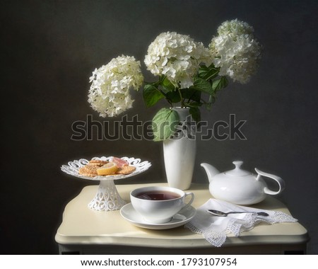 Still life with tea and bouquet of hydrangea flowers