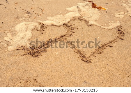 Sign on to hearts being washed away by a wave. Concept end of love and relationship.