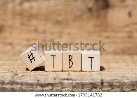 Wooden cubes with a hashtag and the word TBT, Throw back to, social media concept background closeup