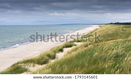 The Curonian Spit is a peninsula with sand dunes that separates the Curonian Lagoon from the Baltic Sea. Curonian Spit in 2000 included in the UNESCO World Heritage List.  Royalty-Free Stock Photo #1793145601