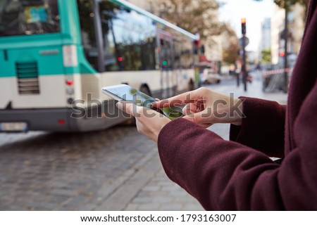 Woman using smartphone in the streets of Paris, France. Royalty-Free Stock Photo #1793163007