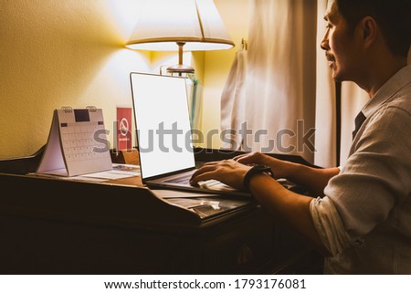 Businessman busy working on laptop in hotel room