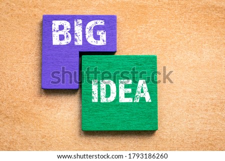 BIG IDEA concept. Colored wooden blocks, puzzle and mind game. Orange background