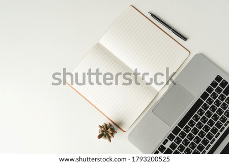 Open laptop with blank notebook, view from above. Workplace concept