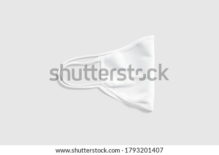 Blank white fabric folded face mask mockup lying, gray background, 3d rendering. Empty protect cotton bandage mock up, top view. Clear save visard with cord for healthcare template.