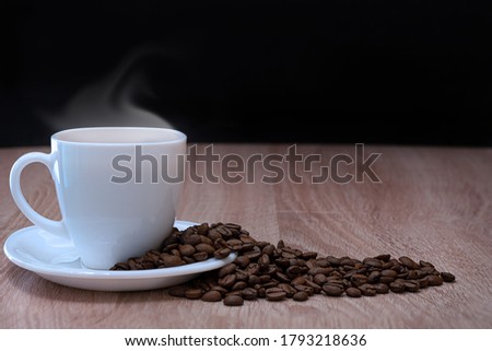Close-up of a coffee Cup and scattered coffee beans. High quality photo