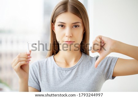Stop smoking, a young woman holding a broken cigarette