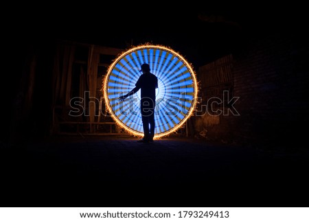 people posing standing with amazing circle light painting as the backdrop