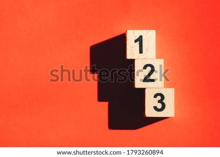 Wooden block number using as business and financial concept - Orange background
