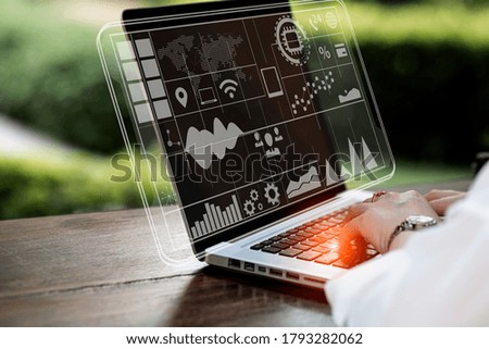 Double exposure of businesswoman hand  working on laptop with business financial virtual chart, Digital marketing concept, Background toned image blurred.