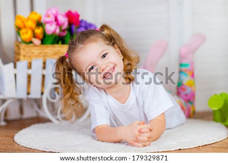 Cute happy girl posing at spring flowers background