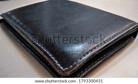 A wallet is a small case that can be used to carry small personal items.