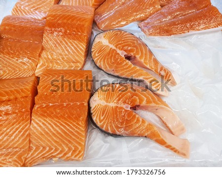 Fresh raw salmon fish cut without head on tray in hypermarket for selling.

