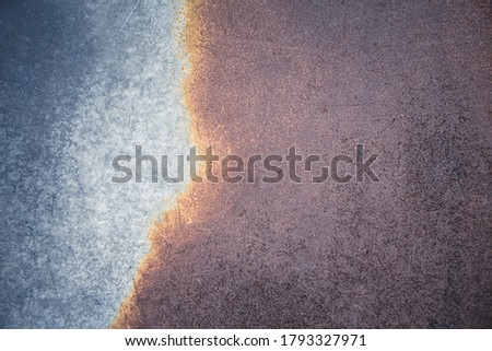 Abstract background of rusted metal with blue and orange tones. Textured retro background for overlay or addition of text.