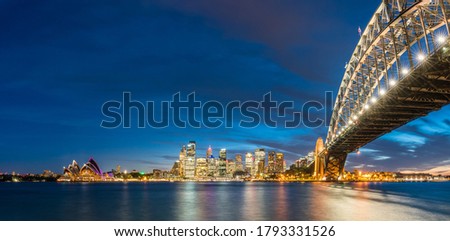 Colorful Sydney downtown skyline with harbor bridge at night in Sydney, New South Wales, Australia.
