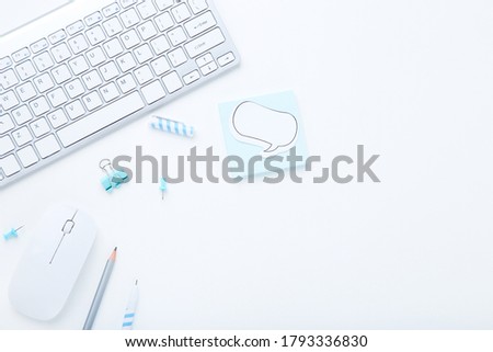 Computer keyboard with mouse and office supplies on white background