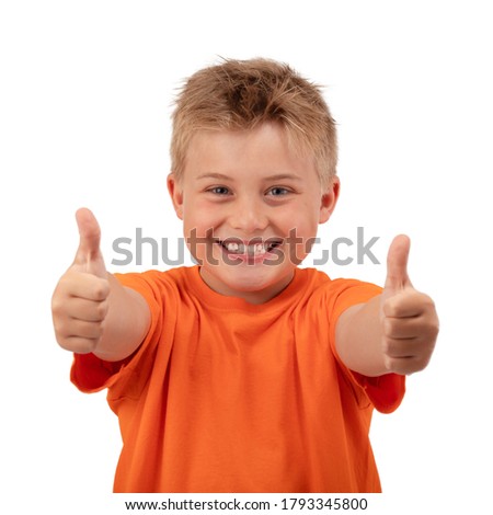 CHEERFUL BOY SMILING HAPPY POINTING THUMBS UP ISOLATED ON WHITE BACKGROUND