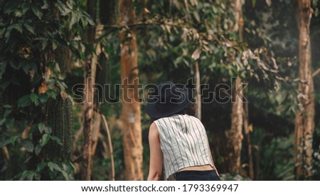 Asian young woman looking in the mystery forest. balance, spirituality and nature concept. Copy Space