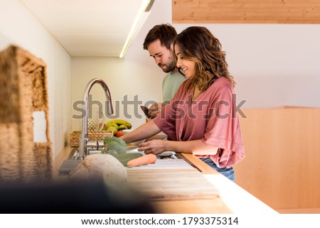 Young couple chilling out while preparing the lunch Royalty-Free Stock Photo #1793375314