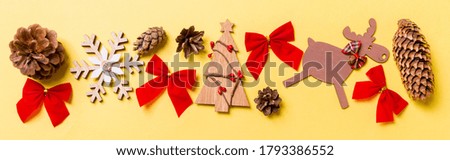 Top view of Banner holiday ornament made of Christmas decorations on colorful background. New Year time concept with copy space.