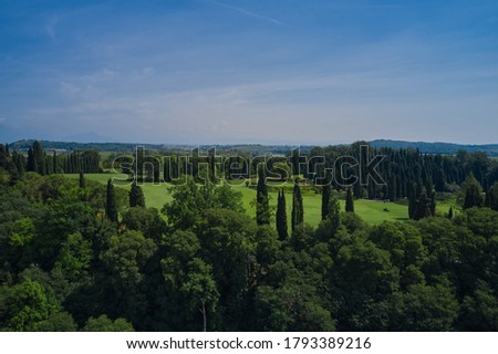 Garden park, northern Italy. Park near Lake Garda. A lovely green lawn grass in the park. Aerial view.