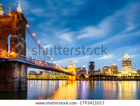 Nighttime view of John A. Roebling Suspension Bridge over the Ohio River and downtown Cincinnati skyline