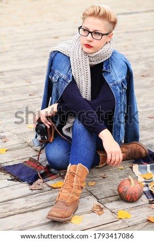 Woman traveler. Cozy fall picnic with mulled wine on lake. Wellbeing, relaxation at nature, traveling concept.