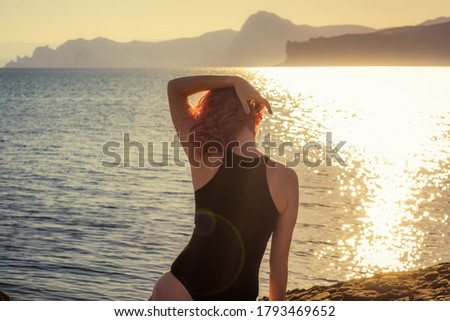 Girl by the sea on the background of nature