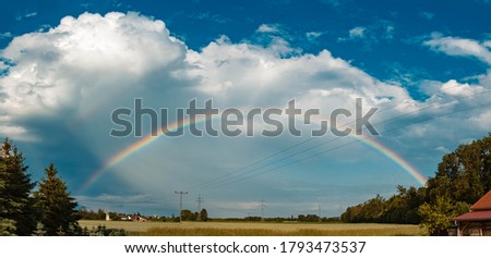 High resolution stitched panorama of a beautiful rainbow near Tabertshausen, Bavaria, Germany