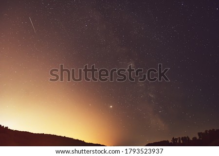 Milky Way, Jupiter and Saturn Planets  and the shooting stars of the Perseid meteor shower in the night.