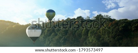 Hot air balloons over forest, space for text. Banner design 