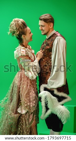 On Big Film Studio Two Talented Actors of Female and Male Playing a Beautiful Lovely Couple Wearing Renaissance Clothes and Look at Each Other. The Scene on Green Screen.
