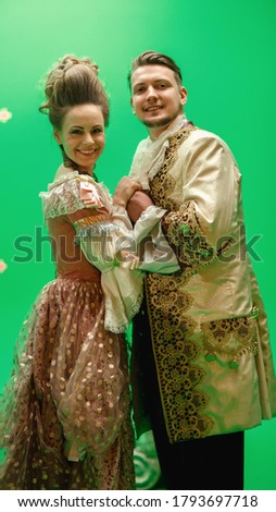 On Big Film Studio Two Talented Actors of Female and Male Playing a Beautiful Lovely Couple Wearing Renaissance Clothes and Look on Camera. Scene on Green Screen.