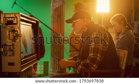 Director Looks at Display Controls Shooting Period Drama Movie. Green Screen CGI Scene with Actors Wearing Renaissance Costumes. Crew Shooting High Budget Movie.