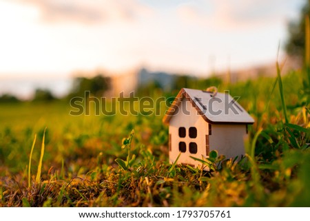 Wooden house model in the savings plan for people living in society, buying a house to live a dream of public life